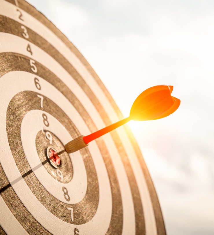 Close Up Shot Red Darts Arrows In The Target Of Dartboard Center On Dark Blue Sky Background. Business Target Or Goal Success And Winner Concept.