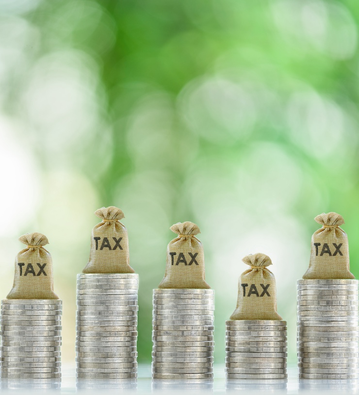 Tax Collection, Tax Credit And Benefit, Financial Concept : Tax Bags Rest Atop Coin Stacks, Depicting Mandatory Financial Charge, Type Of Levy Imposed By A Government On A Taxpayer, Individuals, Etc.